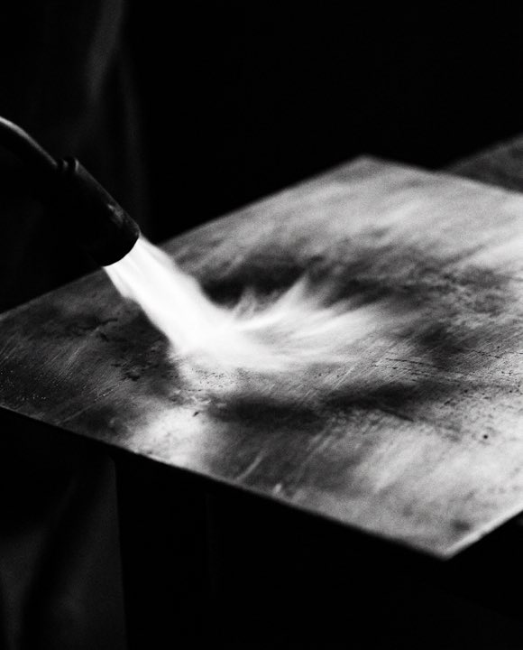 Torch flame drawn across a copper sheet