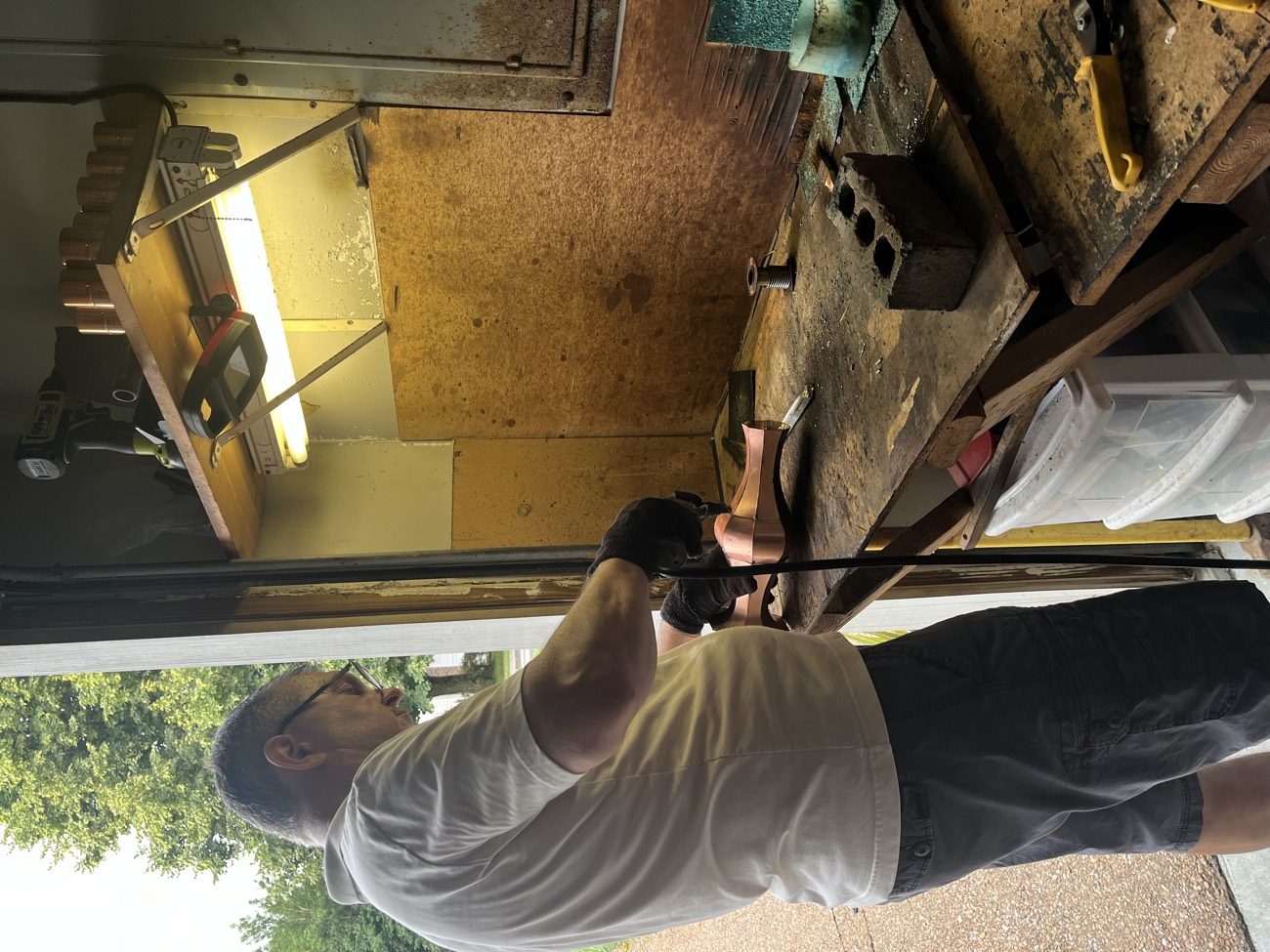 Sergei Tysyachuk cutting and forming solid copper at his workbench in Franklin, Tennessee